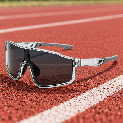 Gray Shield Sport sunglasses resting on a running track
