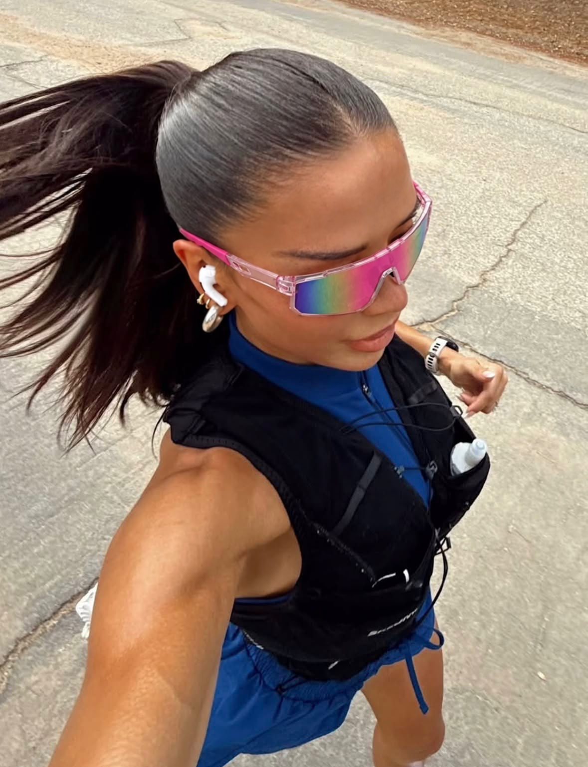 Runner outdoors wearing pink mirrored shield sunglasses